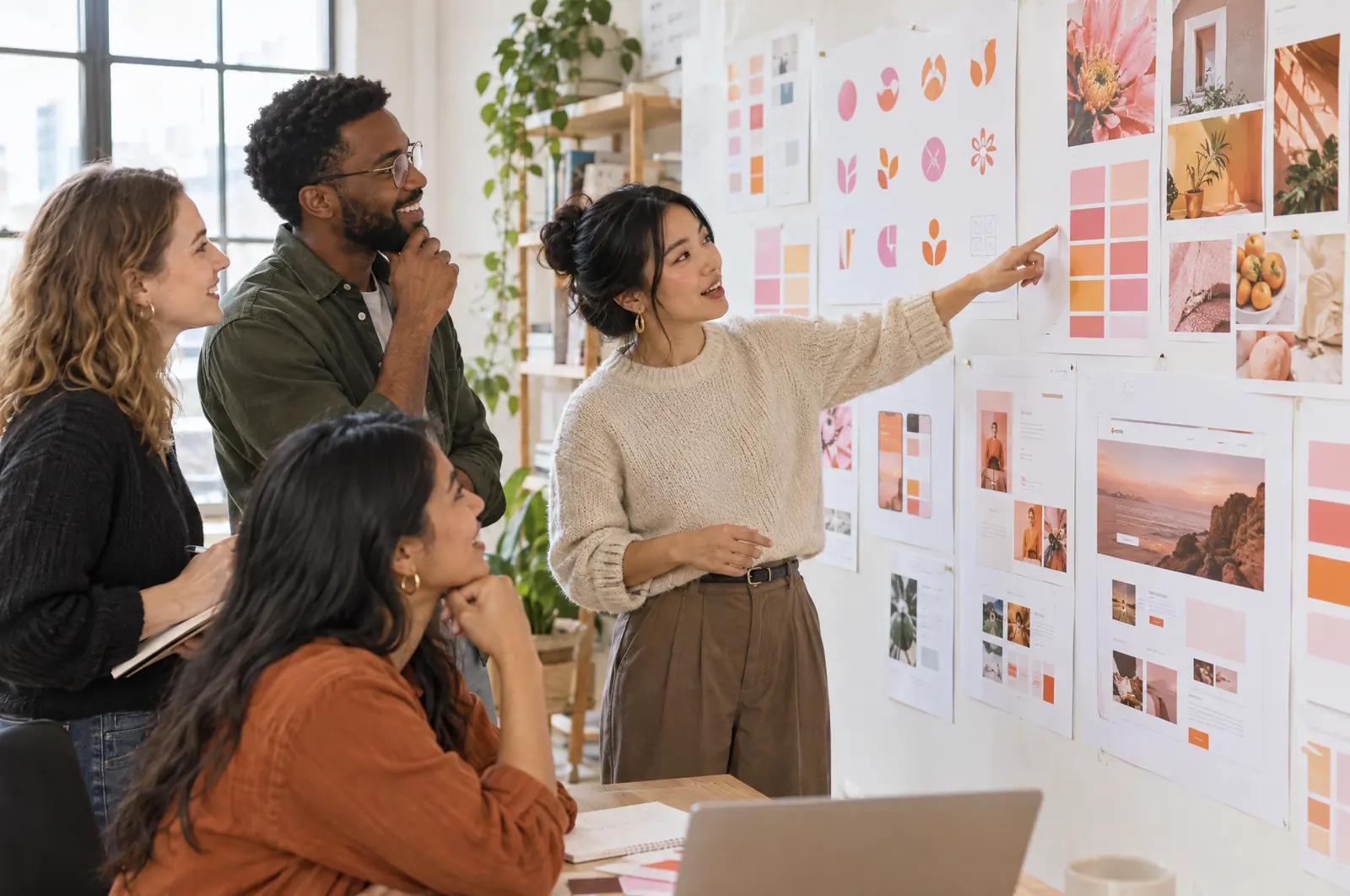 A team discussing brand design boards in a bright studio